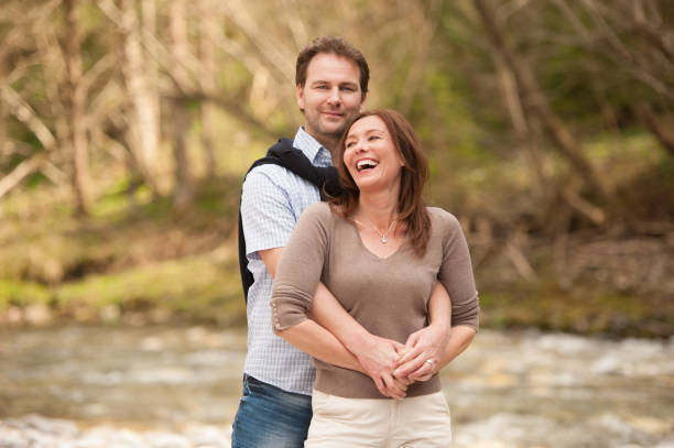 istock Young Couple Enjoying Togetherness on River´s Shore 1006243764
