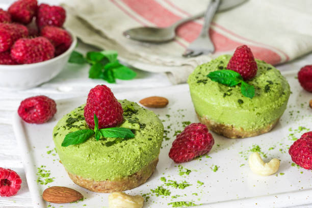 istock green matcha vegan raw cakes with raspberries, mint, nuts and spoons for breakfast 1006243802