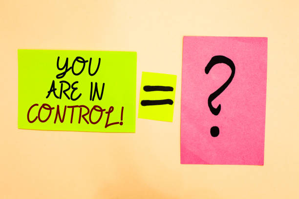 istock Writing note showing You Are In Control. Business photo showcasing Responsibility over a situation Management authority Written on green sticky note on yellow and question mark on pink paper. 1006246712