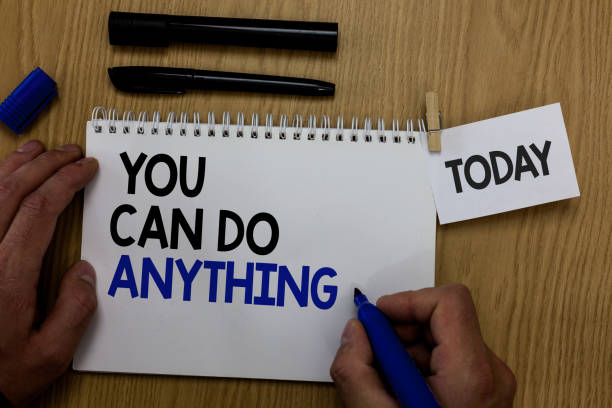 istock Word writing text You Can Do Anything. Business concept for Motivation for doing something Believe in yourself Hand hold pen notepad with words paperclip grip note paper woody base black pen. 1006247418