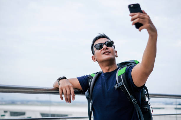 istock Man alone travel with backpack and laptop 1006257850