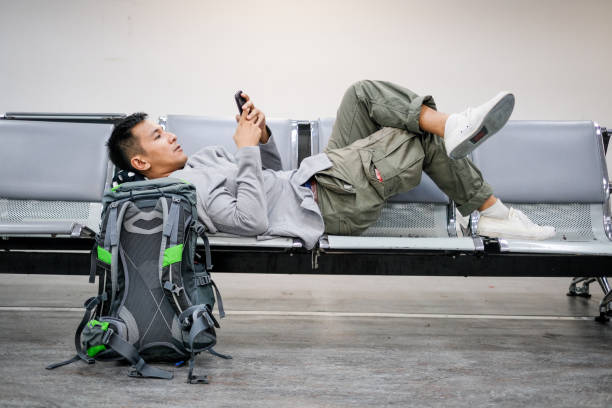 istock Businessman waiting and using phone at airport 1006257914