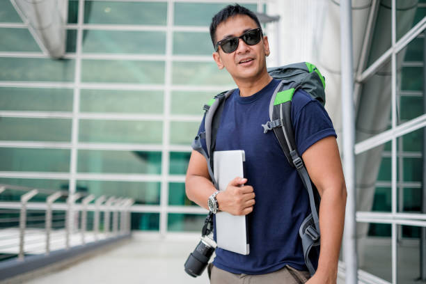 istock Man alone travel with backpack and laptop 1006260338