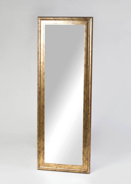 Large golden framed mirror isolated on white background mirror in a new apartment - Large golden framed mirror isolated on white background wooden bleachers stock pictures, royalty-free photos & images