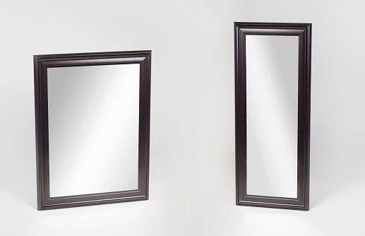 Large and small black framed mirrors isolated on white
