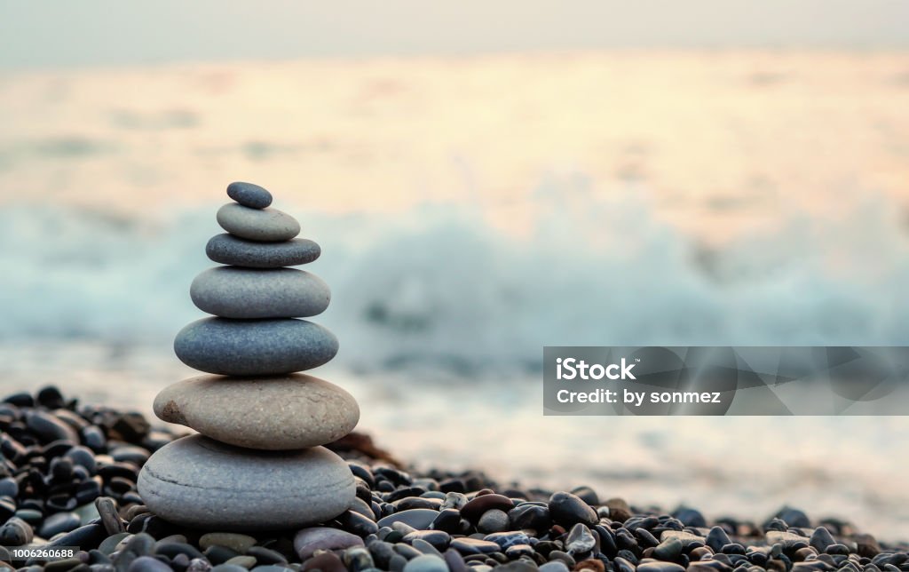 made of stone tower on the beach and blur background Balance Stock Photo