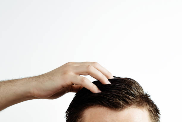 istock Hand on a man's hair on a white background. 1006274152