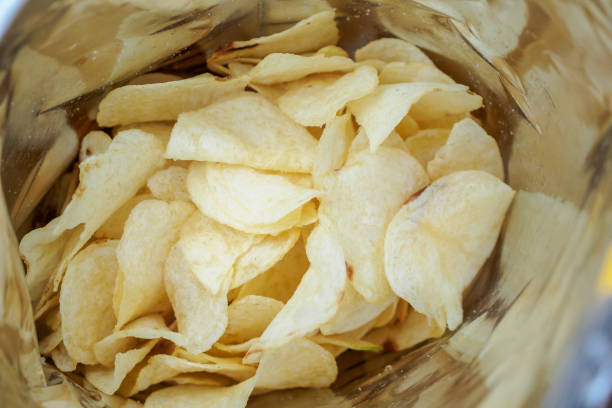 istock Potato chips in open snack bag close up 1006276816