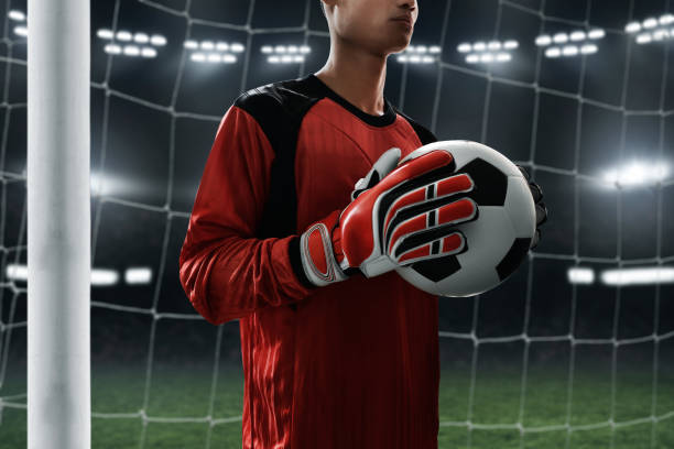 istock Soccer goalkeeper holding soccer ball 1006291664