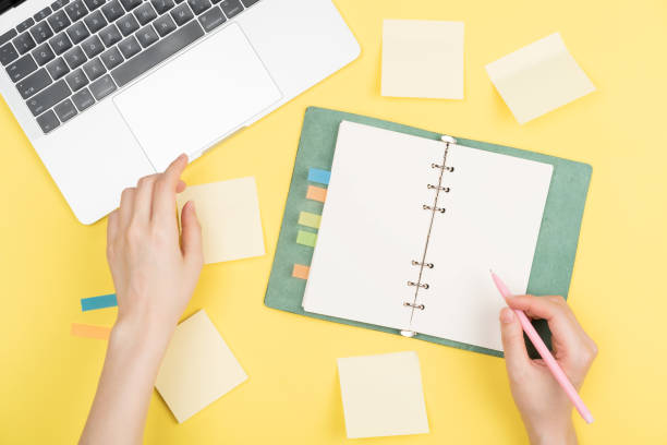 istock girl's hand writing in notepad 1006294602