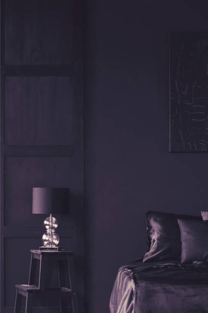 istock Dark violet hotel bedroom interior 1006297816