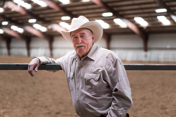 istock Senior cowboy at a horse stable 1006297900