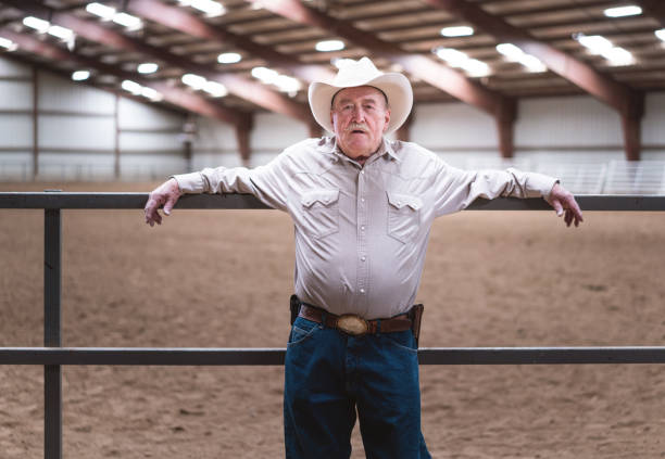 istock Senior cowboy at a horse stable 1006297922