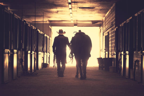 istock Cowboy at a horse stable 1006298064