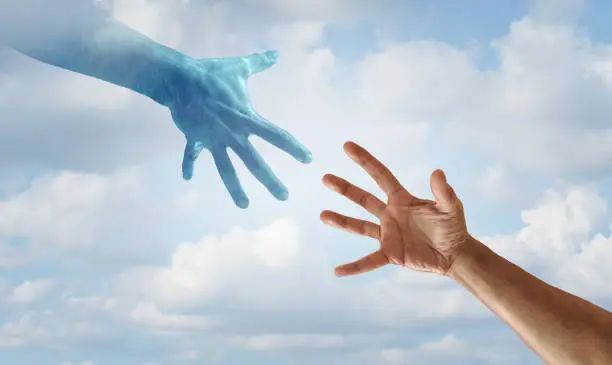Helping hand concept as saving hands reaching towards each other as a hero rescue and spiritual help idea.