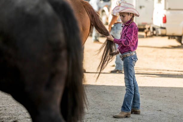 istock Cowgirl Braiding a Horse Mane and Tail 1006300736