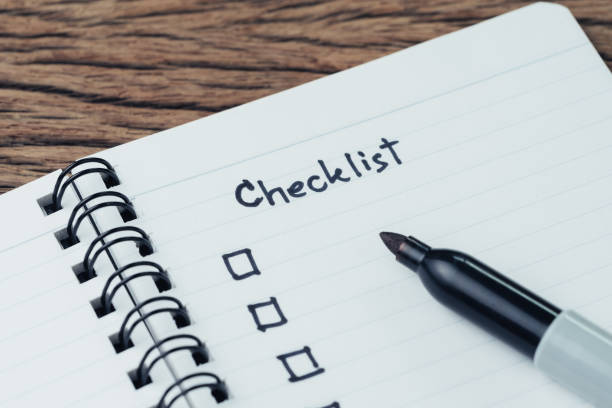 istock Notepad with pen and handwriting headline as Checklist with check box on wood table, to do list, prioritize or reminder for project or plan 1006307402