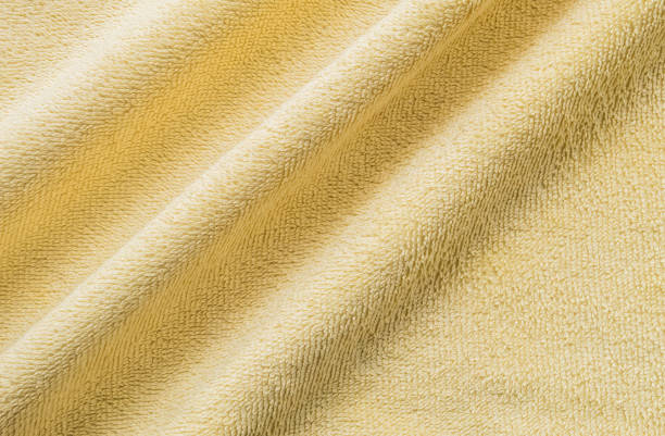 istock Closeup wrinkled yellow napkin fabric background 1006350106