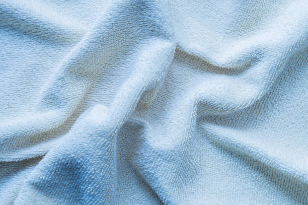 istock Closeup wrinkled blue napkin fabric background 1006352448