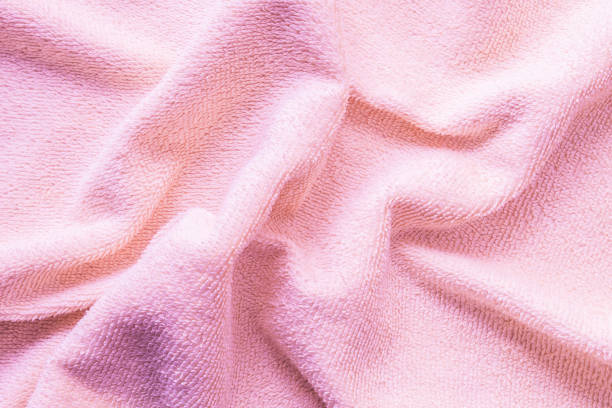 istock Closeup wrinkled pink napkin fabric background 1006352520