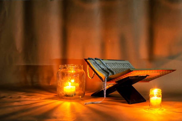 istock The Quran is placed on a wooden stand.Light candles. 1006355000
