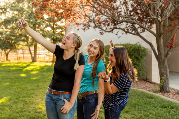 istock Happy Teens Taking Selfies Outdoors 1006367854