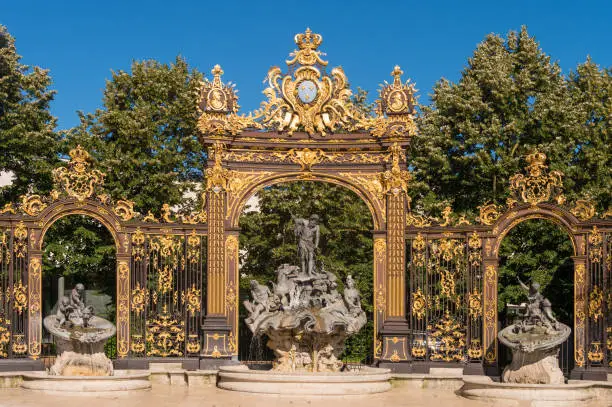 Golden gate to the Place Stanislas square and Neptune Fountain in Nancy, France.