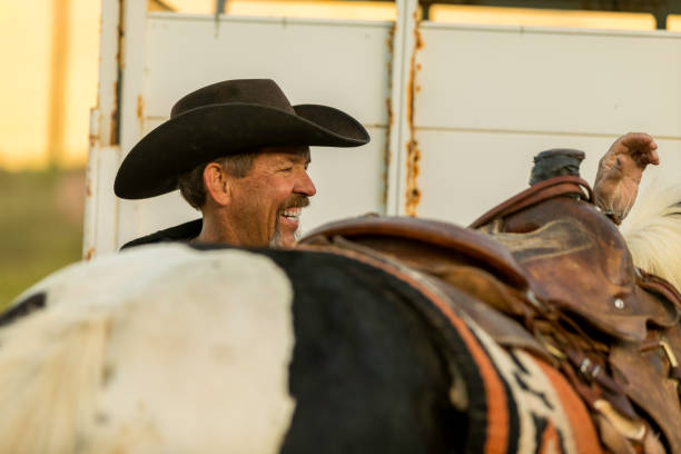 istock Cowboy Rancher Brushing Horse Early Morning Light 1006371354