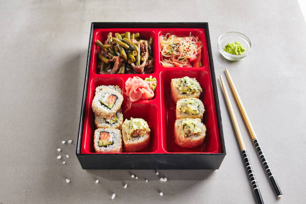 Fresh Food Portion in Japanese Bento Box Fresh Food Portion in Japanese Bento Box with Sushi Rolls, Salad and Main Course empty bento box stock pictures, royalty-free photos & images