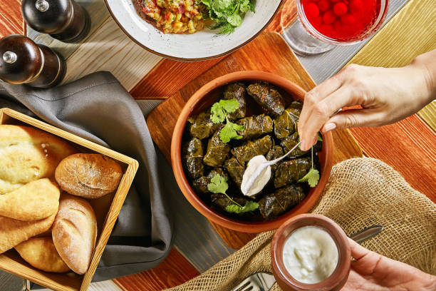 istock Traditional Turkish Dolma and Hand with Spoon Top View 1006373772