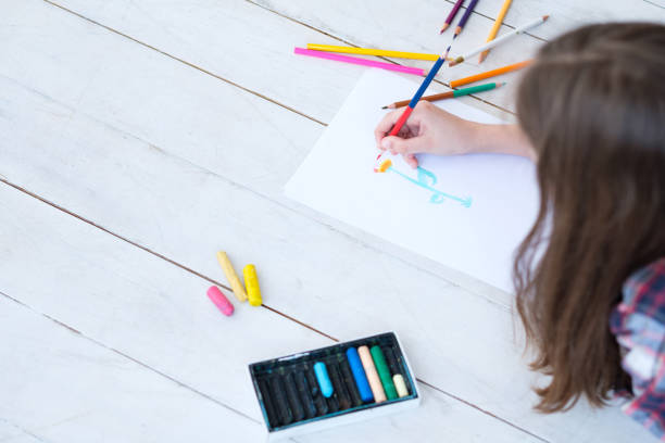 istock kid creativity art leisure girl drawing flower 1006380952