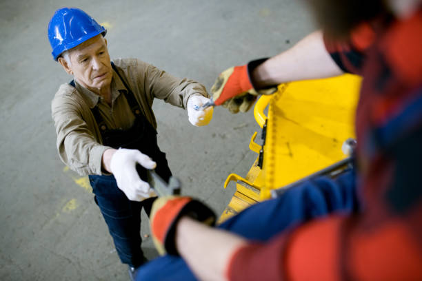 Mechanic assisting colleague