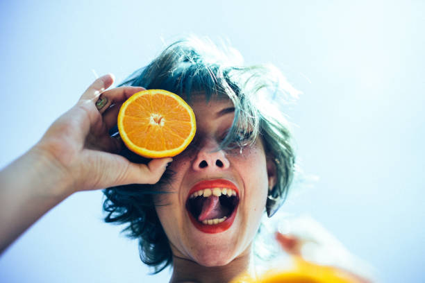 istock Cute woman loves oranges 1006383816