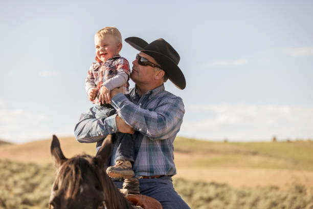 Father and Son on Horseback stock photo