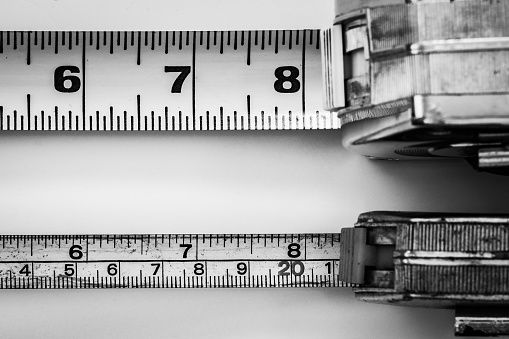 Inch Measuring. Big and small tape measure tools. Comparison.