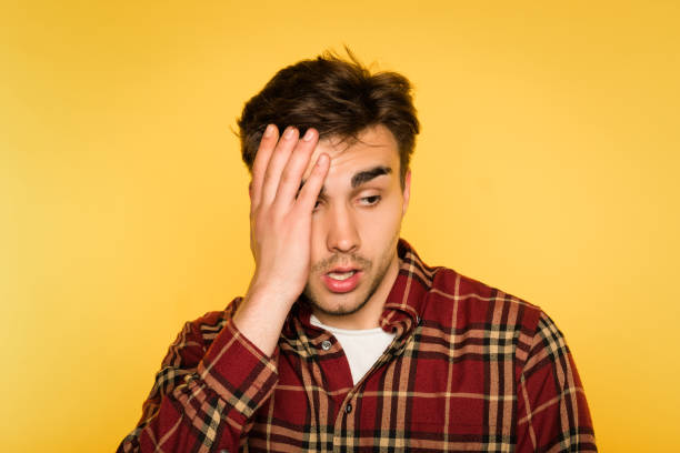 istock dumbfounded shocked man clutch head dismay emotion 1006386652