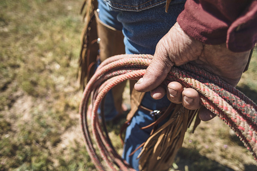 High quality stock photo of a man holding a lasso on an authentic ranch in Utah.