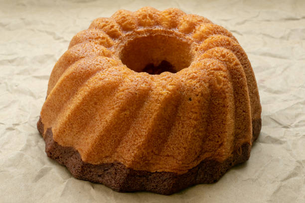 istock Traditional homemadee freshly baked whole marble cake on paper. 1006417536