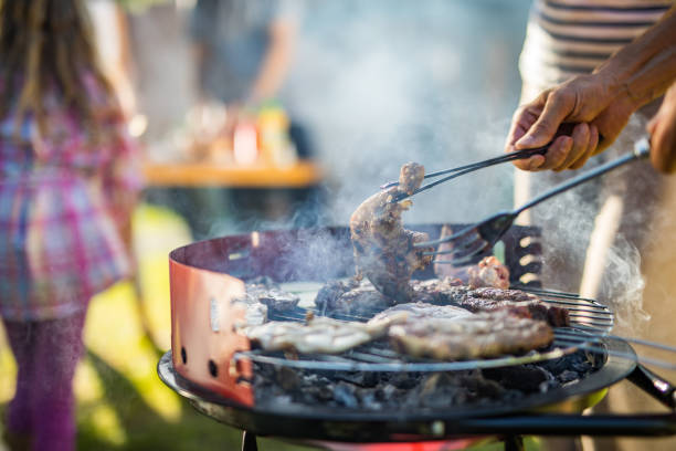 istock Close up of unrecognizable man grilling meat on barbecue. 1006418040