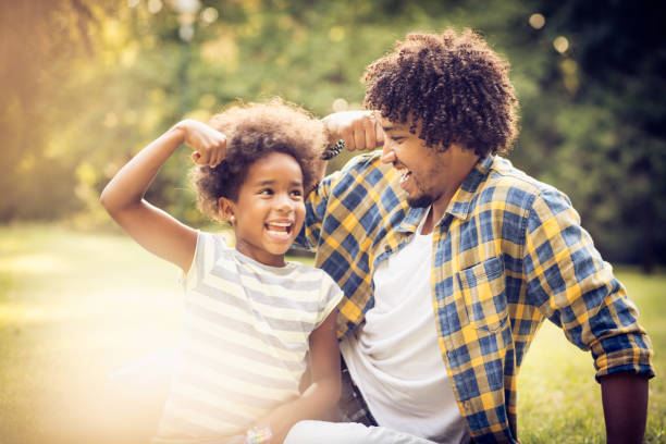 Fun competition. African American father and daughter playing in nature. man laughing hard stock pictures, royalty-free photos & images