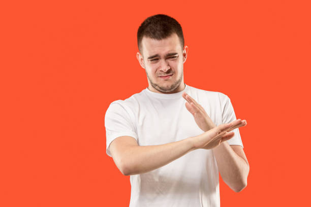 istock Let me think. Doubtful pensive man with thoughtful expression making choice against orange background 1006442216