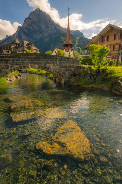 istock Swiss village with church and river 1006446084