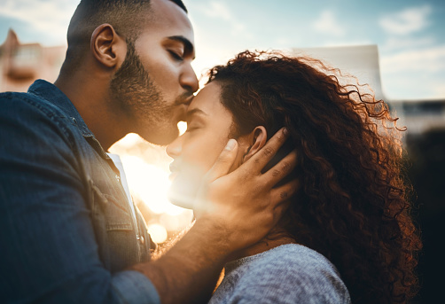 Shot of an affectionate young couple bonding together outdoors