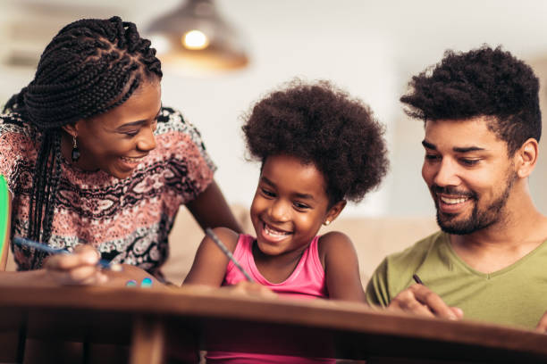istock Mom and dad drawing with their daughter. 1006456176