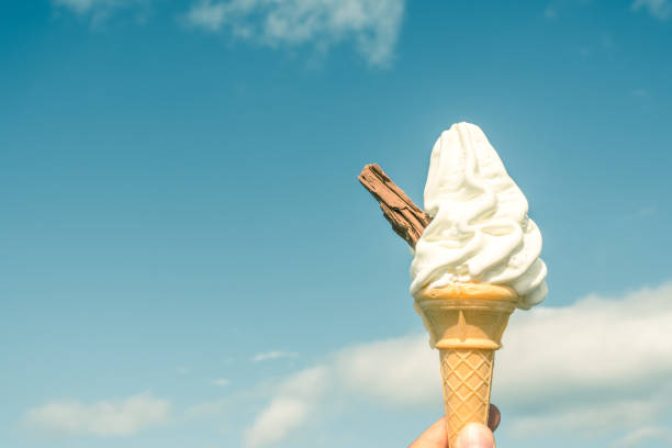 Ice cream in a cone with a chocolate flake stock photo