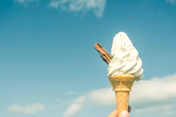 Soft ice cream in a cone with a chocolate flake, against a blue sky.  In Great Britain and Ireland these sorts of ice creams are closely associated with the seaside and summer holidays.  They are often referred to as '99s'.