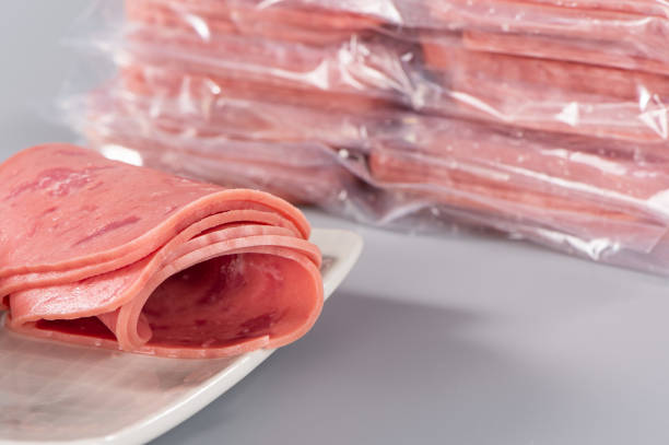 istock Sliced smoked ham isolated on gray background 1006459164