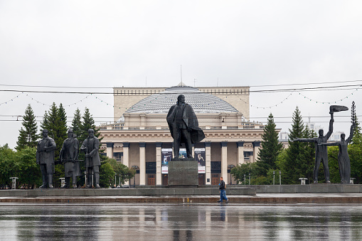 Novosibirsk, Russia - July 22 2018: Statue of Lenin opposite the Novosibirsk Opera and Ballet Theatre (Russian: Новосибирский государственный академический театр оперы и балета) at Lenin square.