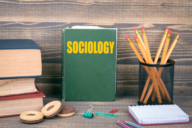 istock Sociology concept. Book on a wooden background 1006462850