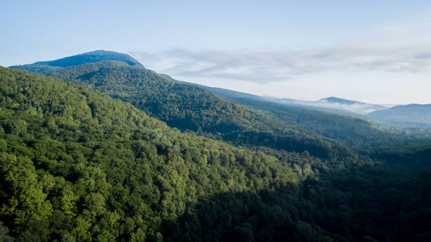 istock Epic Aerial Flight Through Mountain Clouds on Sunrise Beautiful Morning. 1006463566